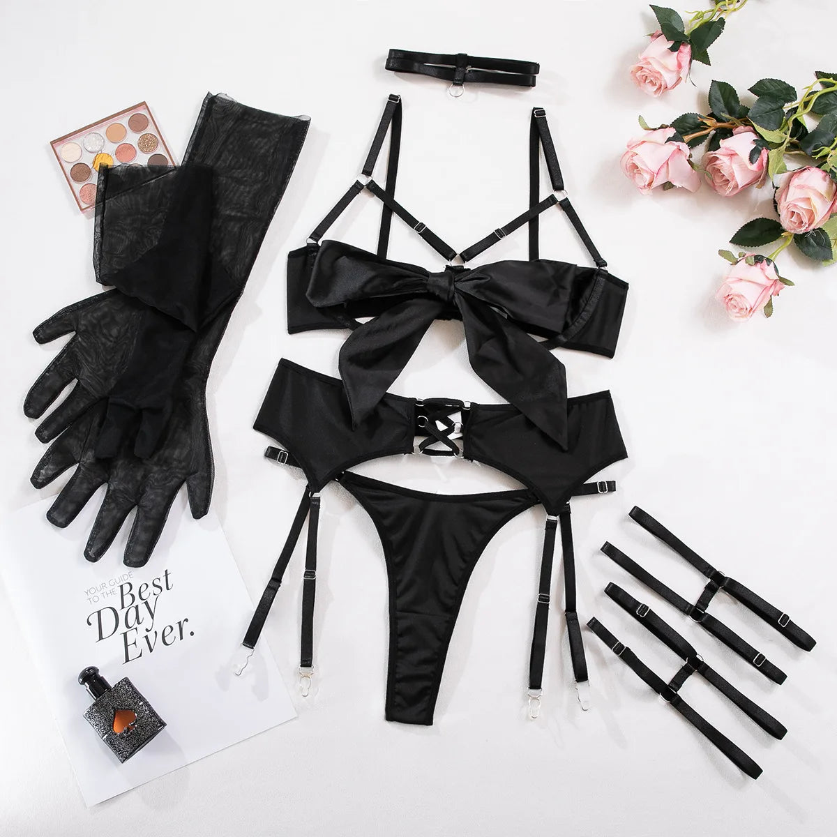 Black lingerie set with accessories on a white background