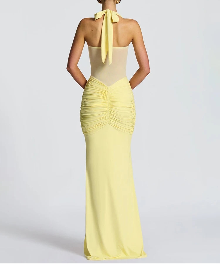 Yellow evening gown with a bow detail on a white background