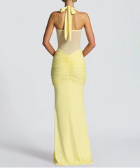 Yellow evening gown with a bow detail on a white background