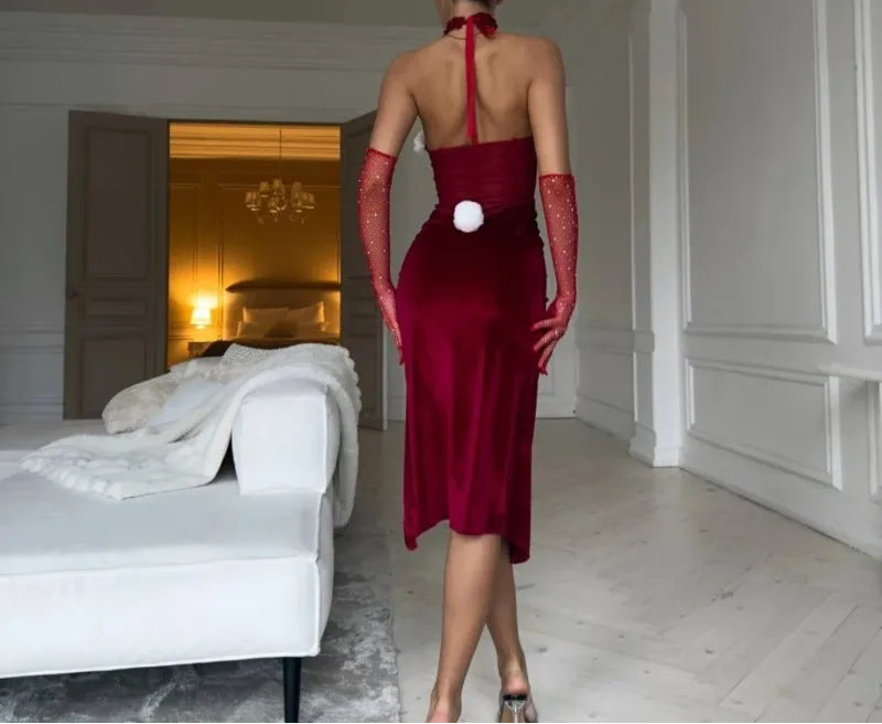 Woman in a red dress and bunny ears walking away in a stylish room.