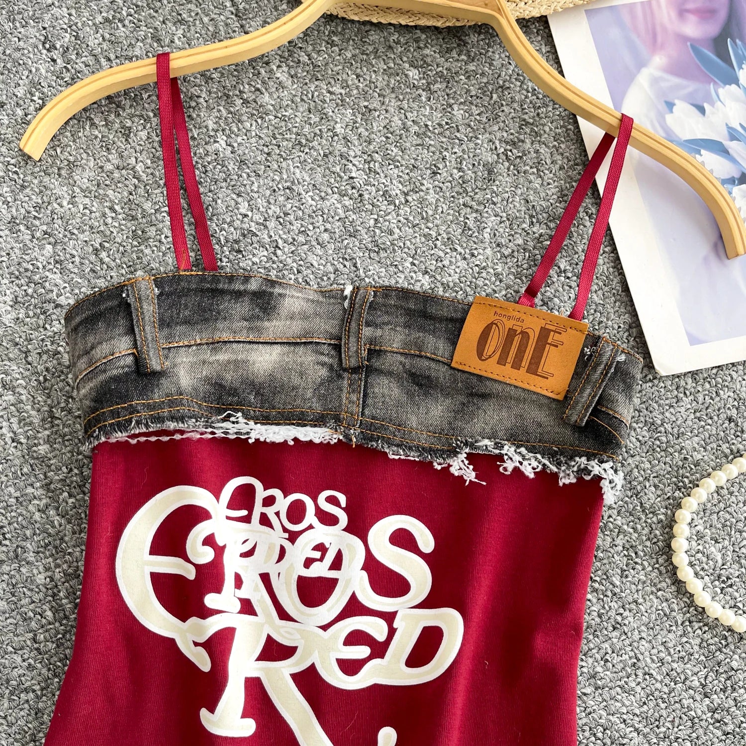 Denim top with red straps and 'Fros Fros Red' logo on a hanger.