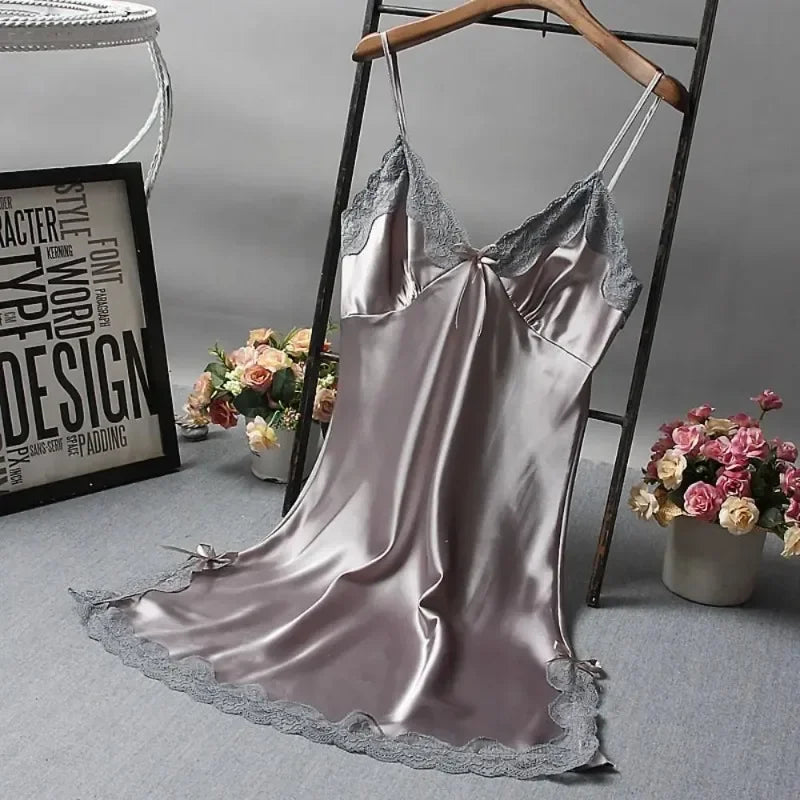 Silky satin slip dress with lace trim on a hanger against a neutral background.
