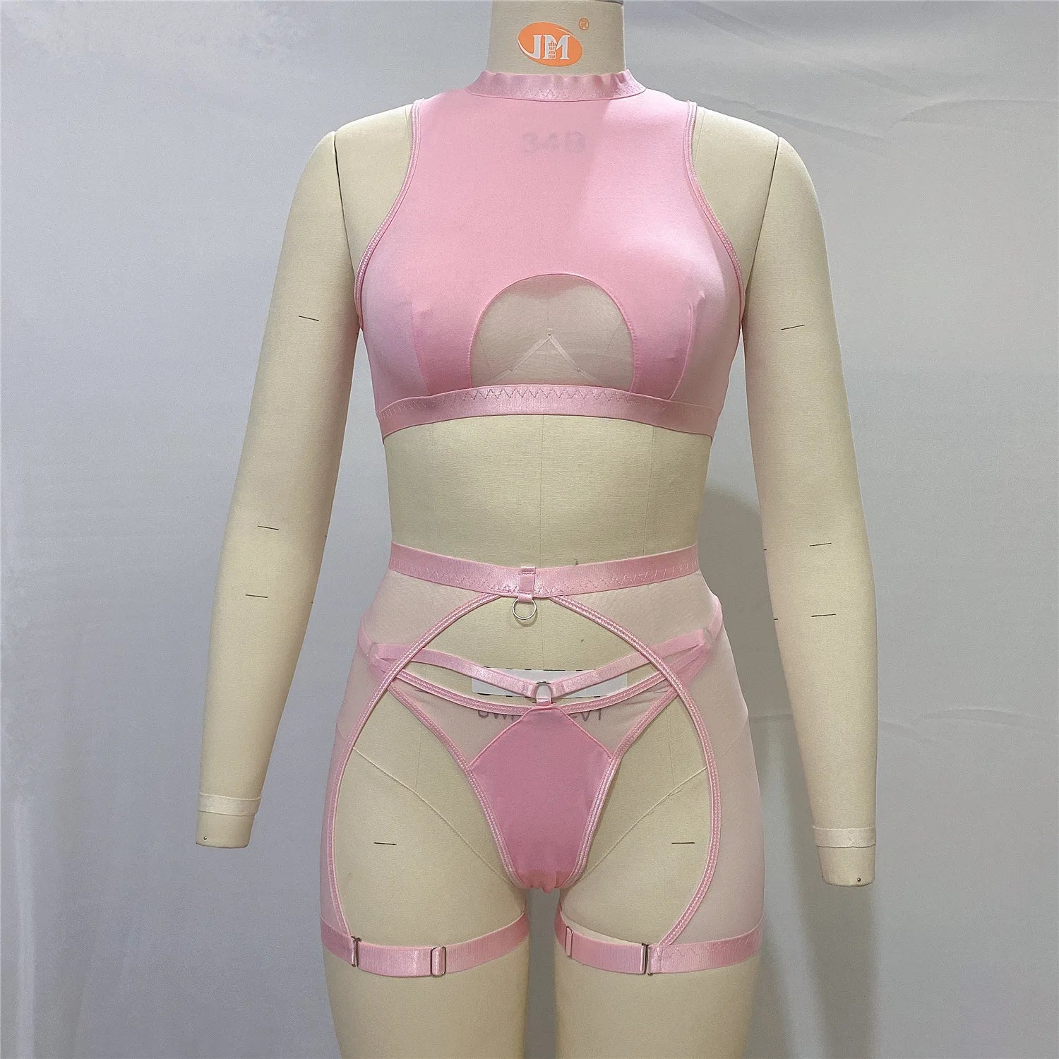Pink lingerie set on a mannequin against a gray background