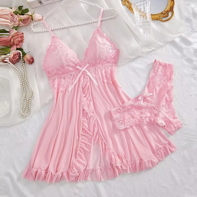 Pink lace nightgown on a white surface with flowers and pearls.