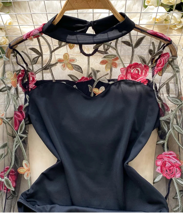 Black garment on a floral-patterned hanger with a decorative background