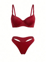 A two-piece bikini set in a deep red color, featuring a structured underwire bra top with thin shoulder straps and matching high-cut bikini bottoms with a front keyhole cutout, displayed against a solid white background.