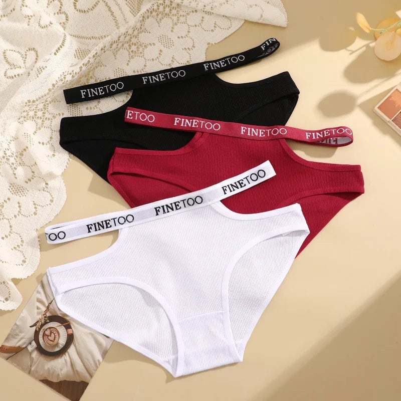 Three pairs of underwear with 'FINEtoo' branding on a beige surface.