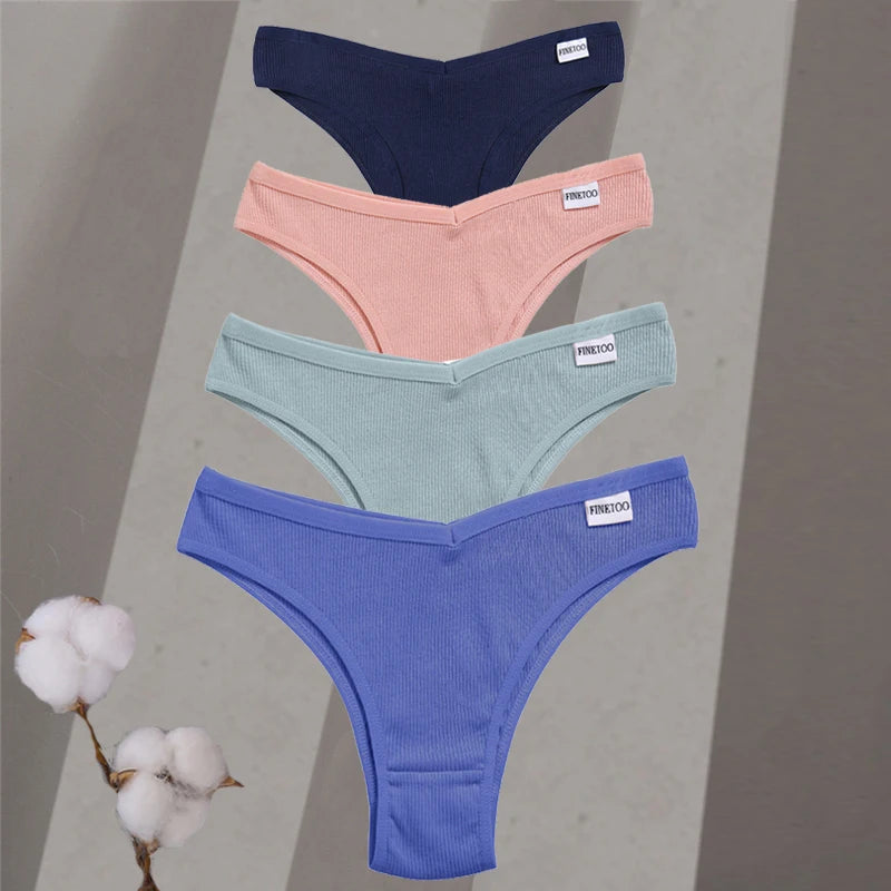 Four pairs of underwear in blue, pink, and green on a gray background with cotton branches.