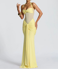 Woman wearing a yellow evening gown with a white background