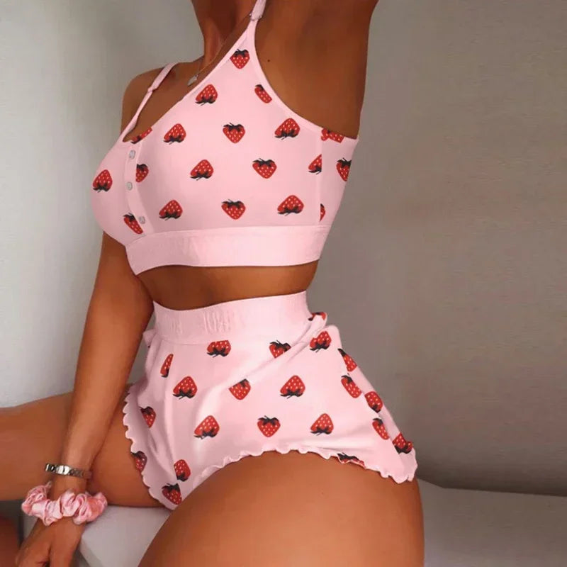 Pink strawberry-patterned outfit worn by a person against a neutral background