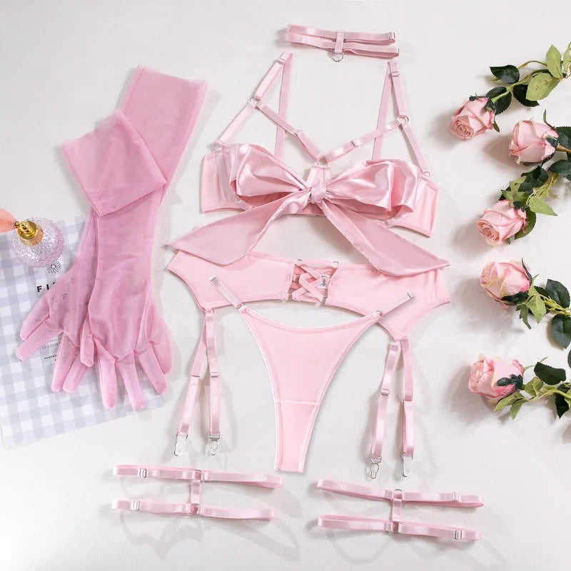 Pink lingerie set with accessories on a light background with flowers.