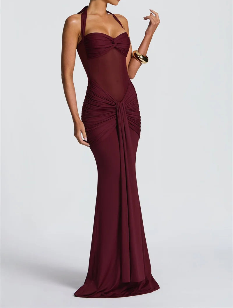 Woman wearing a burgundy evening gown on a white background