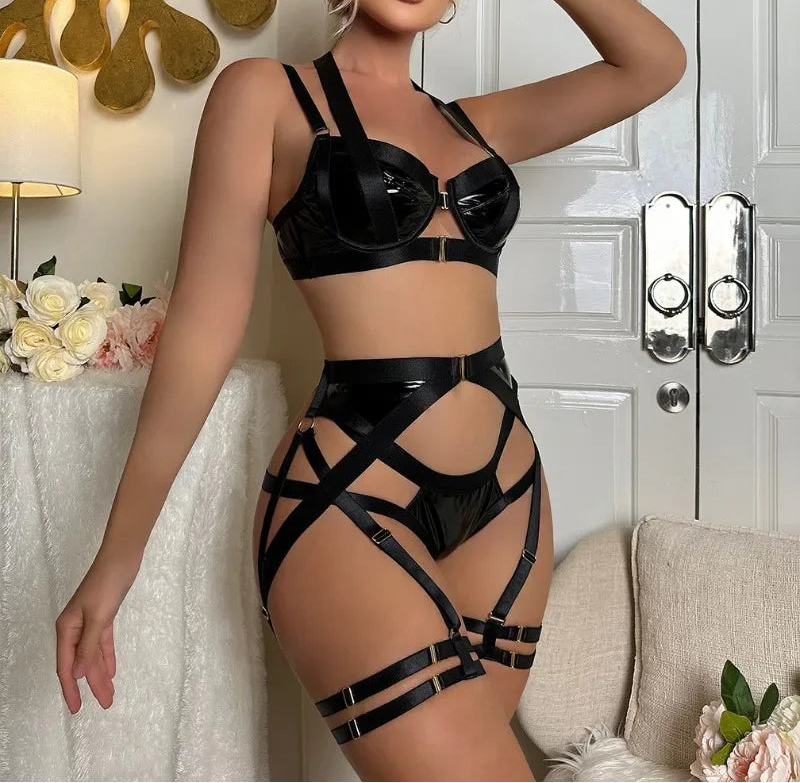 Woman wearing a black strappy outfit in a room with decorative elements.