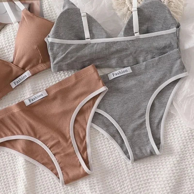 Two pairs of gray and brown underwear with 'Fashion' labels on a textured surface.