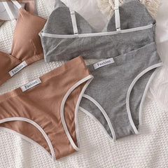 Two pairs of gray and brown underwear with 'Fashion' labels on a textured surface.