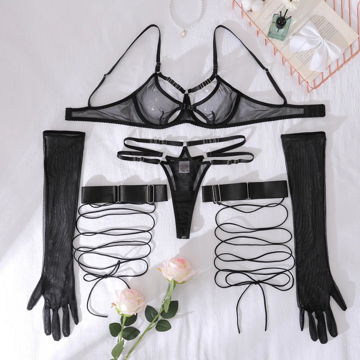 Black lingerie set with gloves and garters on a white background