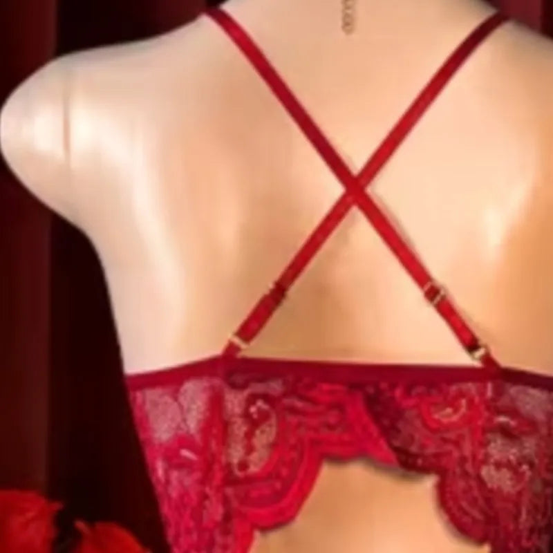 Red lace lingerie top shown from the back on a mannequin, featuring thin adjustable straps that cross in an X shape and a scalloped lace hem.