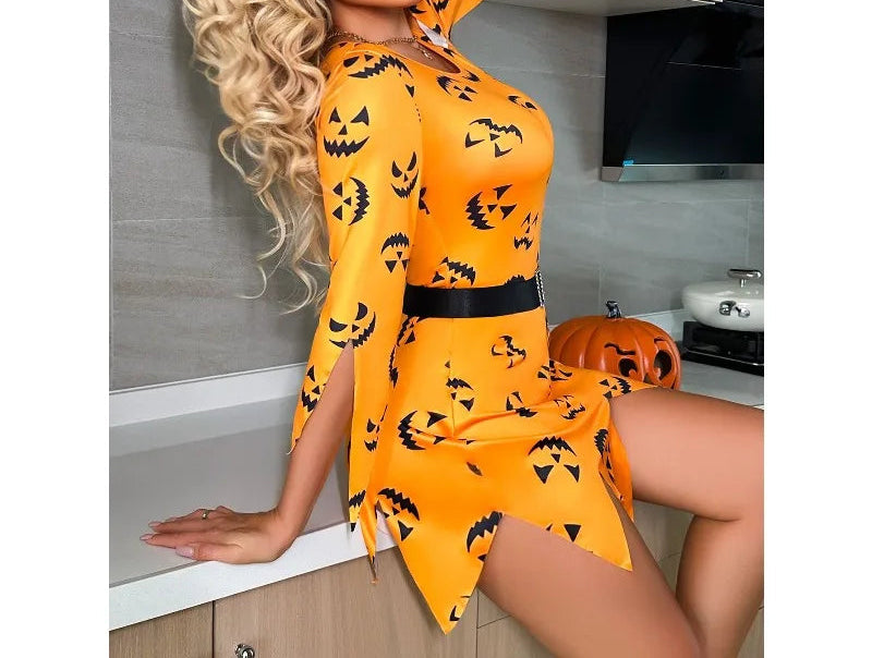 Woman wearing an orange Halloween-themed dress with black jack-o'-lantern patterns in a kitchen.