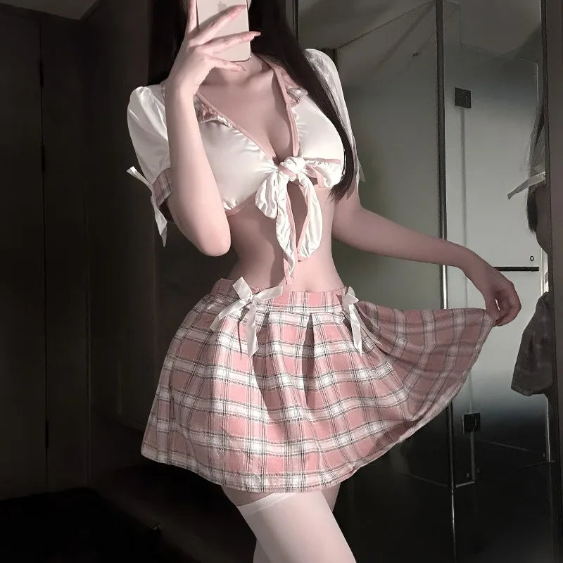 Person wearing a pink and white checkered outfit with a bow tie in a room.