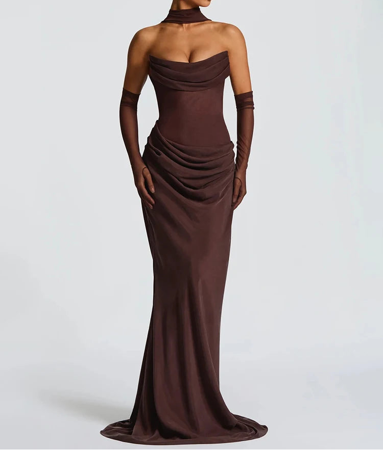 Woman wearing a brown evening gown with long gloves on a white background