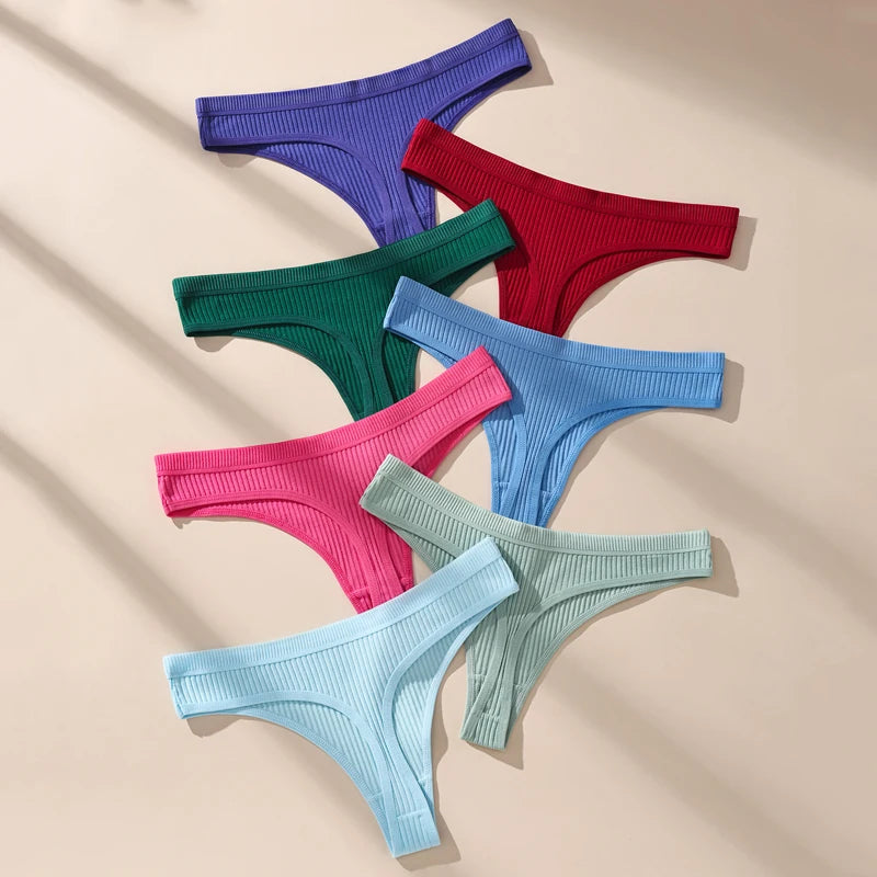 Set of colorful ribbed thongs on a beige background