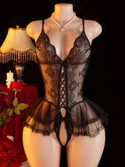 Black lace lingerie set on a mannequin with decorative background