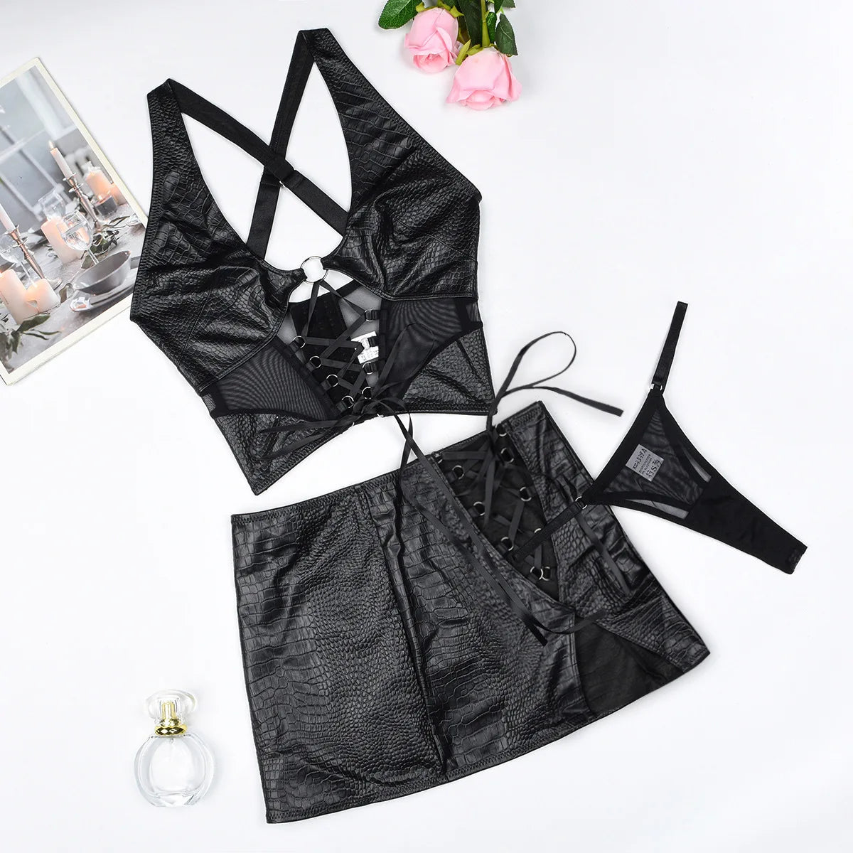 Black lingerie set with a skirt on a white background