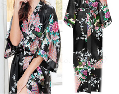 Woman wearing a black floral kimono with a close-up of the garment on a white background.