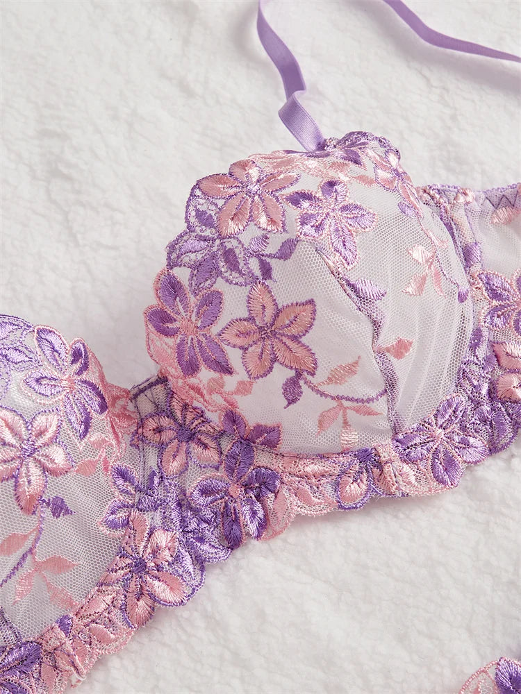 Floral lace bralette with pink and purple flowers on a white background