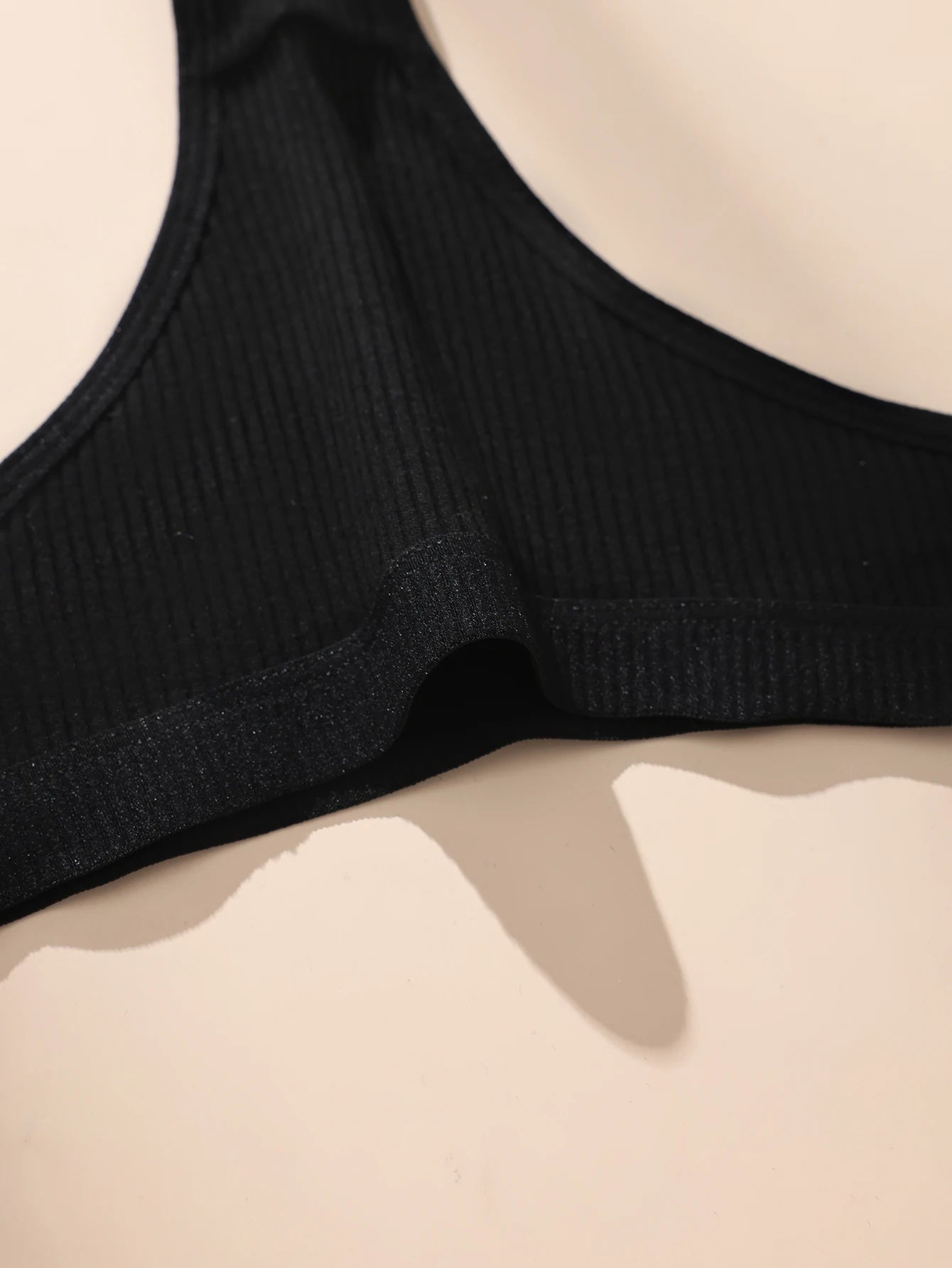 Black ribbed underwear on a beige background