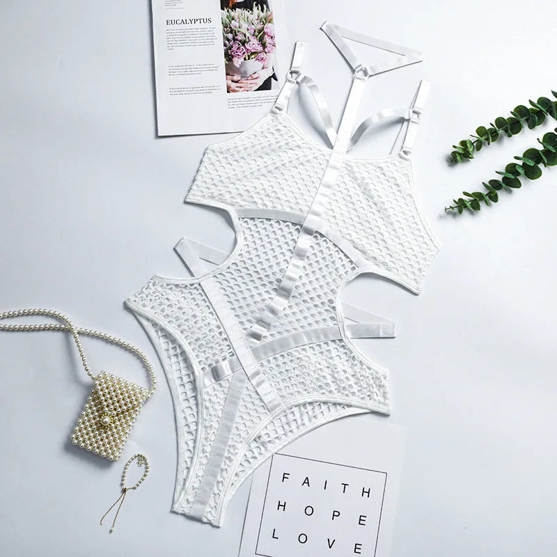 White lace lingerie set on a light gray surface with decorative elements.