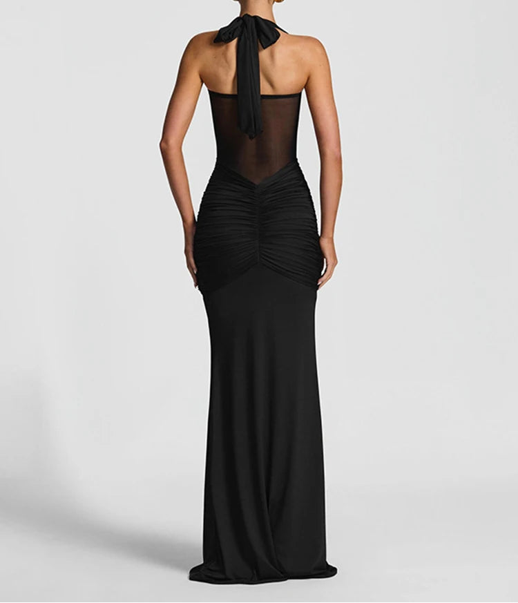 Black evening gown with sheer back on a white background