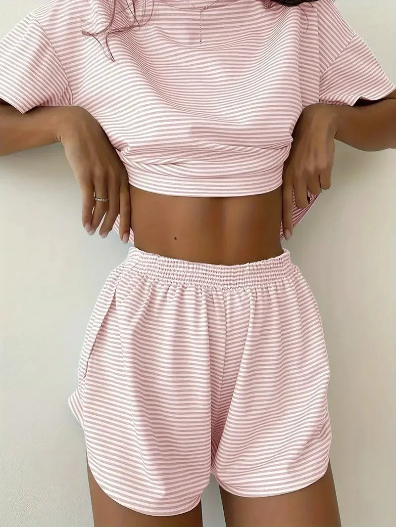 Person wearing a pink and white striped outfit on a plain background