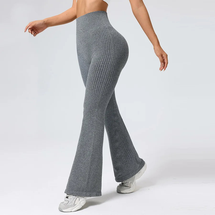 Person wearing gray ribbed knit pants on a white background