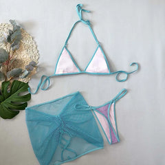 Teal bikini set with pink accents on a light gray background