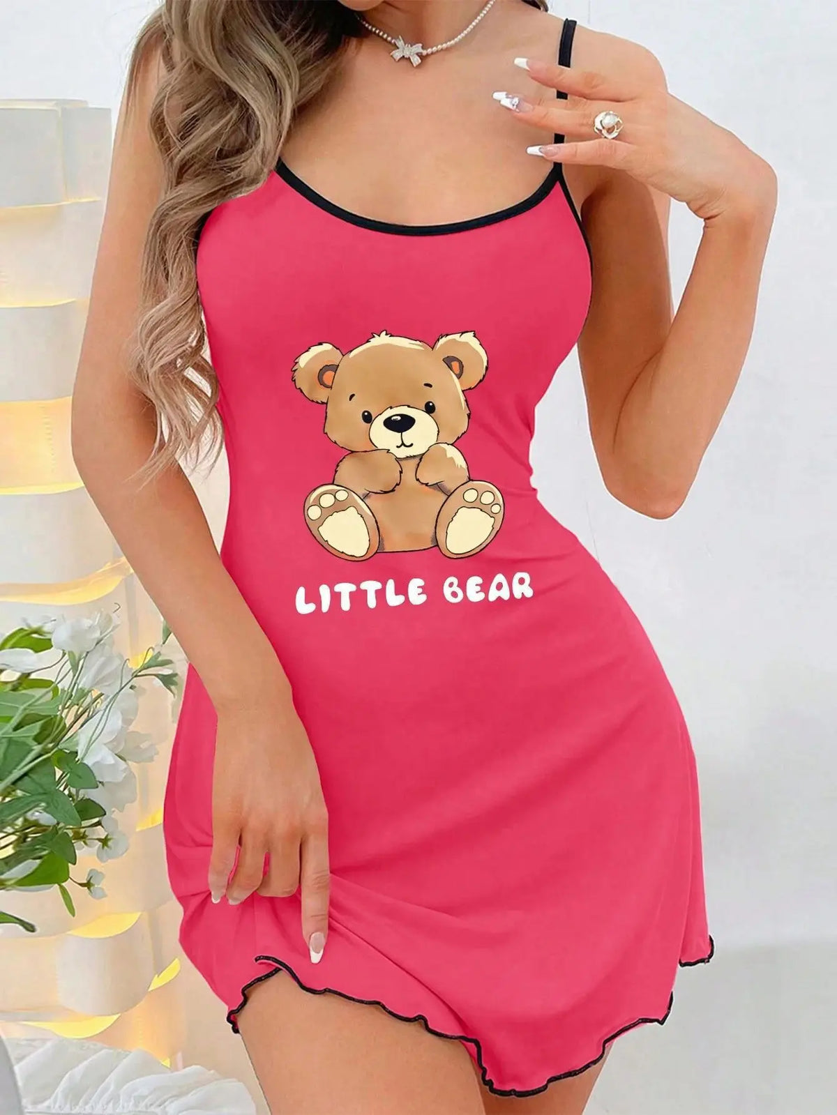 Pink nightgown with teddy bear design and 'Little Bear' text on a white background