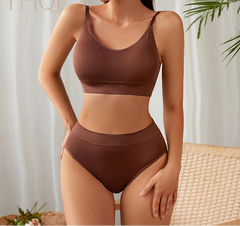 Woman wearing a brown bikini set with a neutral background