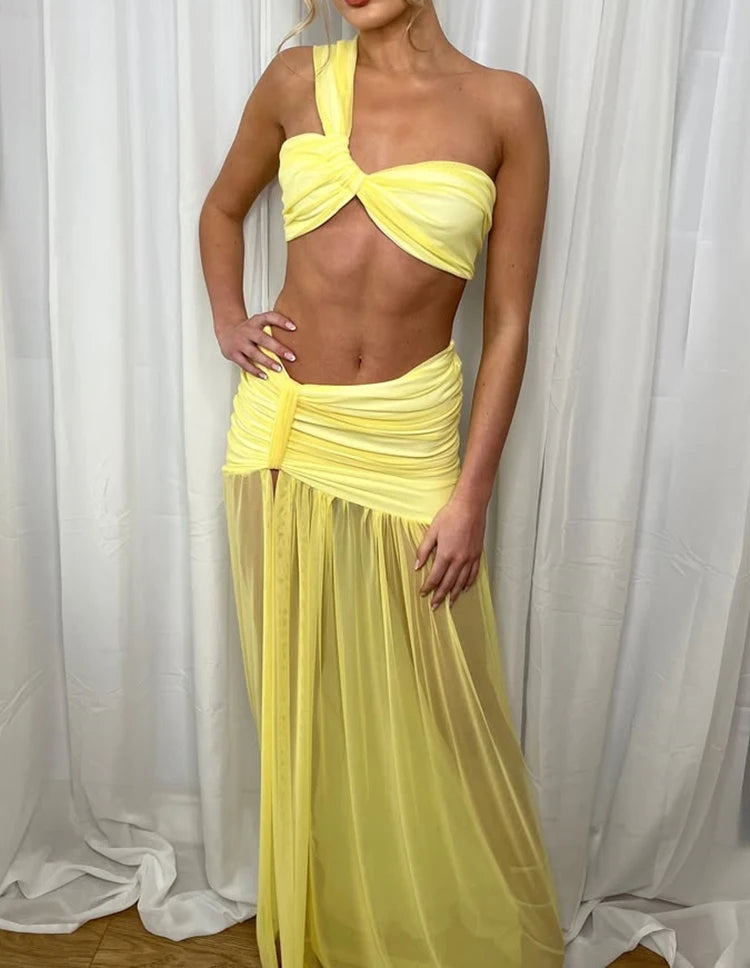 Woman wearing a yellow dress against a white curtain background