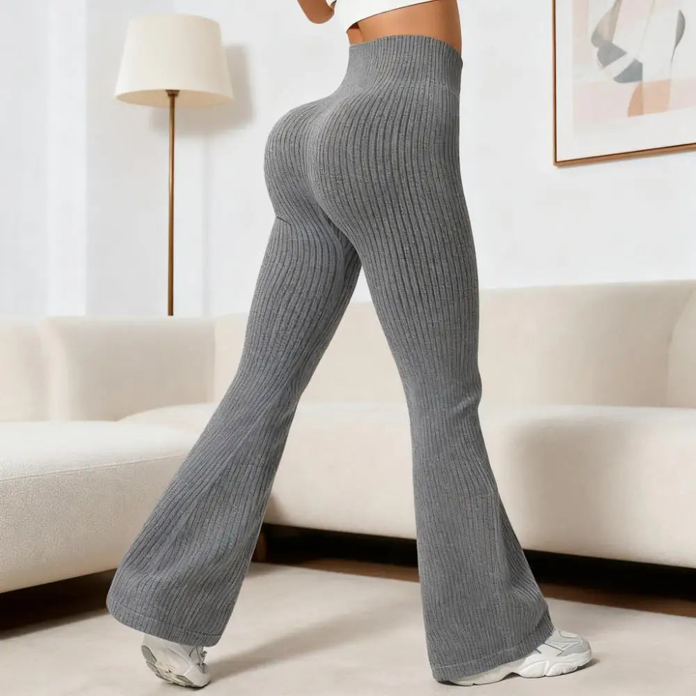Person wearing gray ribbed pants in a living room setting