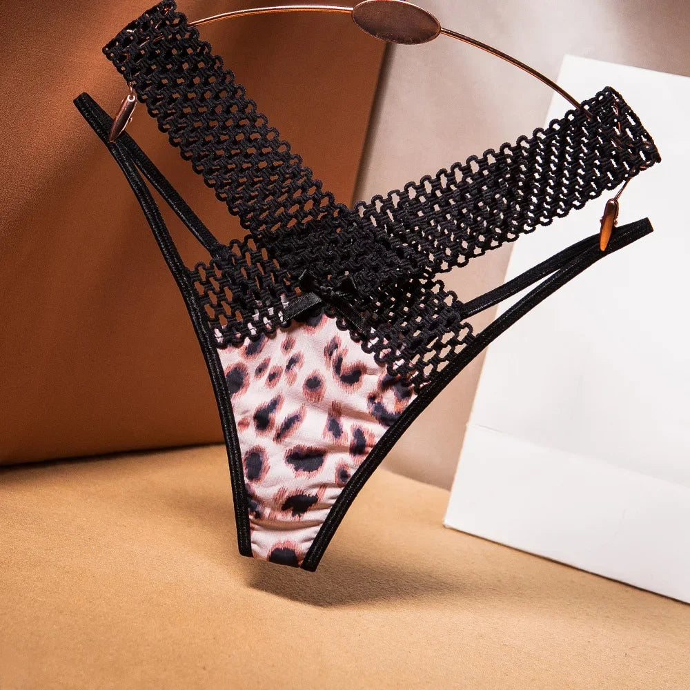 Black lace and leopard print sandal on a beige surface with a white background