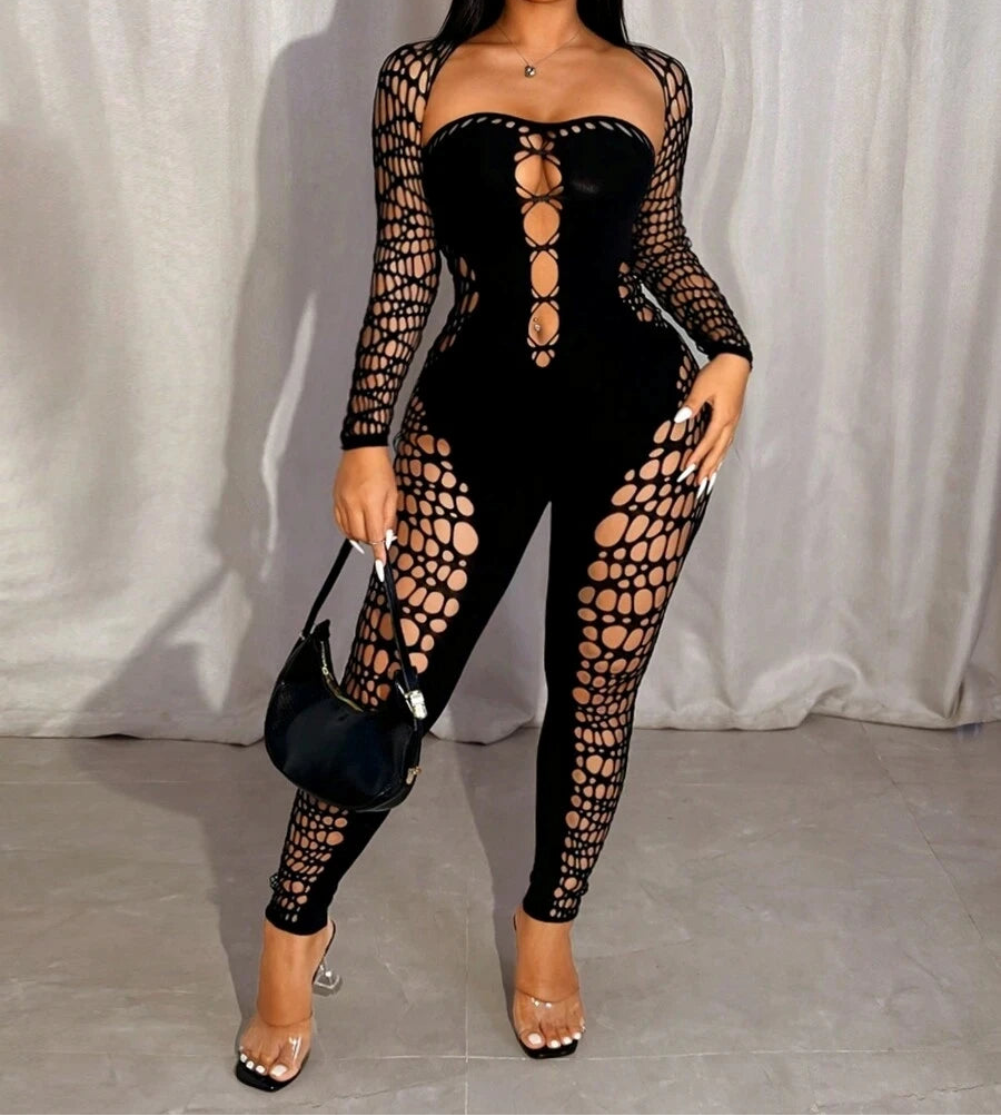 Woman wearing a black lace-up outfit against a white curtain background