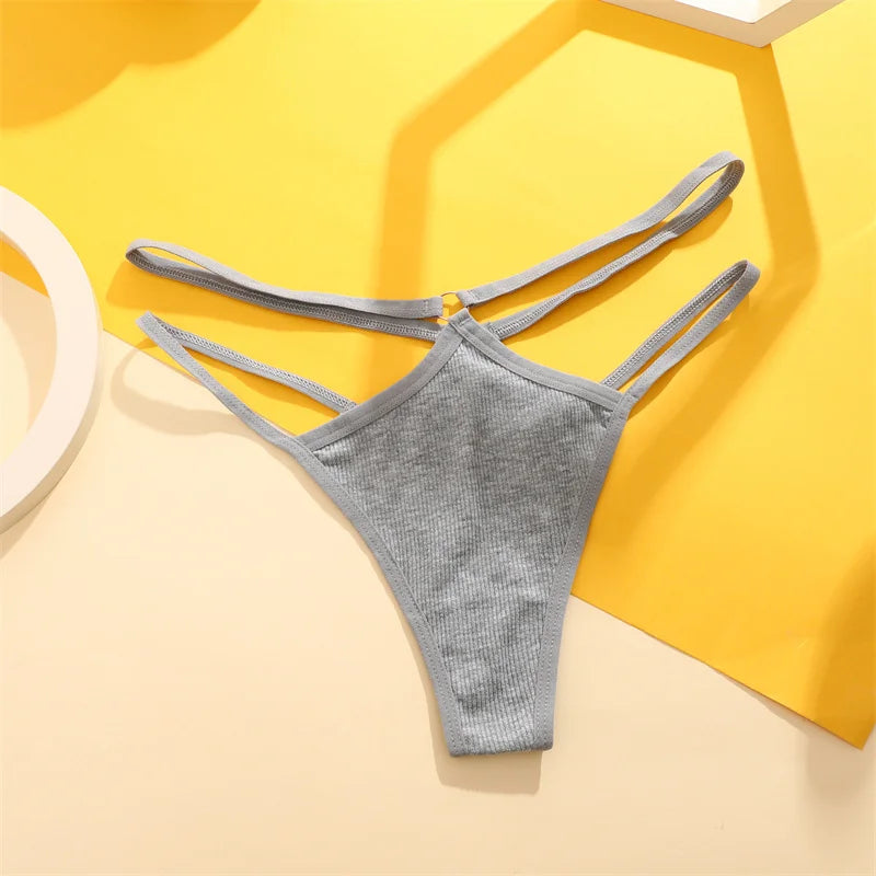 Gray thong with thin straps on a yellow and beige geometric background