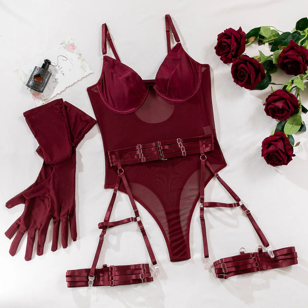 Maroon lingerie set with matching garters and gloves on a white background with roses.
