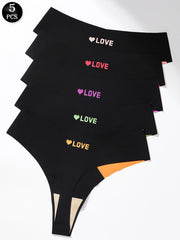 Five pairs of black women's thong underwear stacked diagonally on a white background, each printed with a colorful heart and the word 'LOVE' in different colors (white, pink, purple, green, orange). A black circular badge in the top-left corner reads '5 PCS'.