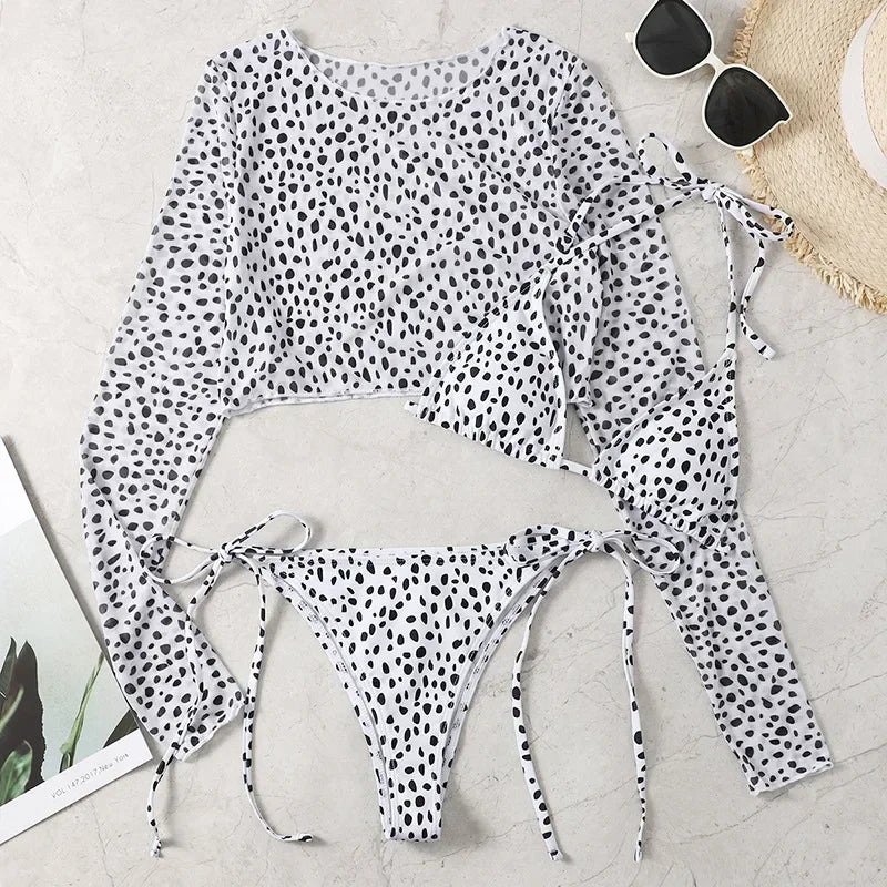 Polka dot swimsuit with matching cover-up on a light surface