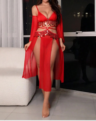 Woman wearing a red outfit with a sheer overlay in an indoor setting.