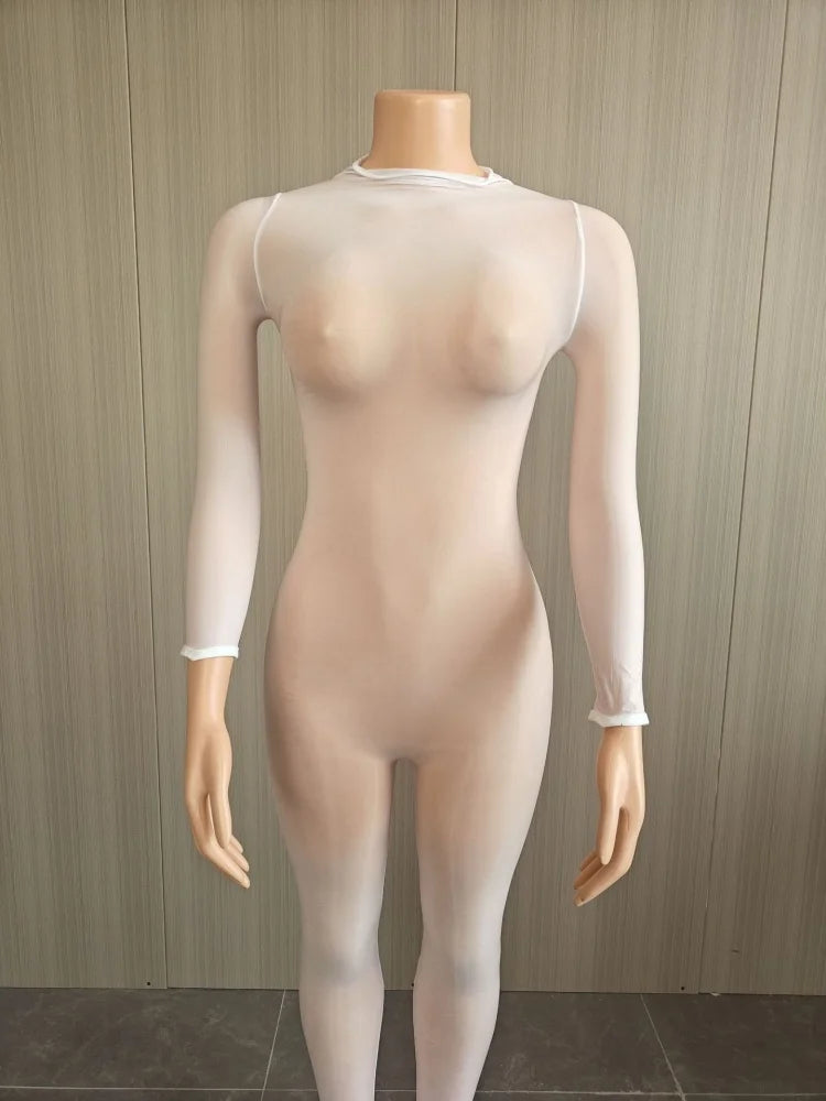 A sheer, skin-toned long-sleeve bodysuit or tights displayed on a mannequin against a light wood-paneled wall.