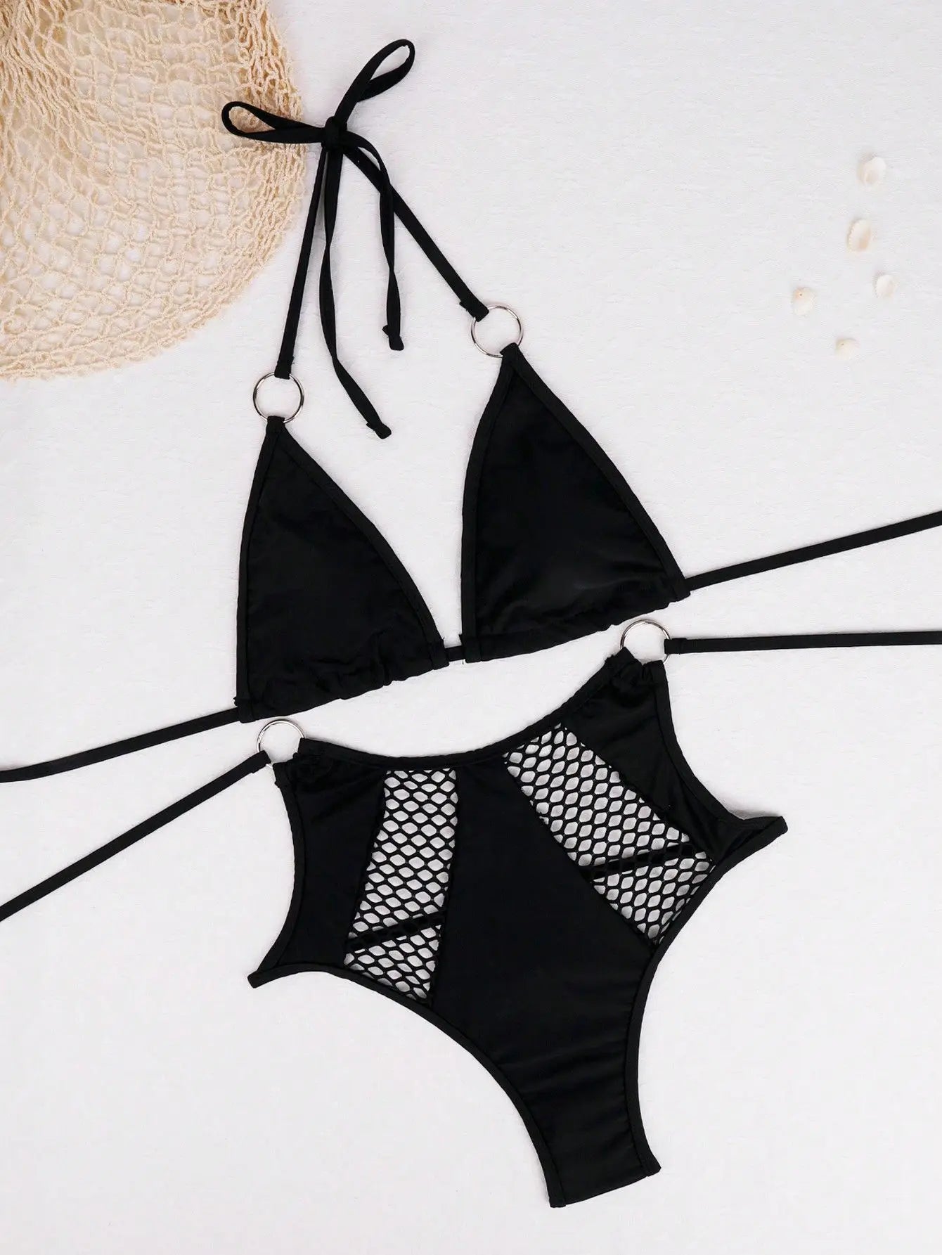 Black bikini set with fishnet details on a white background