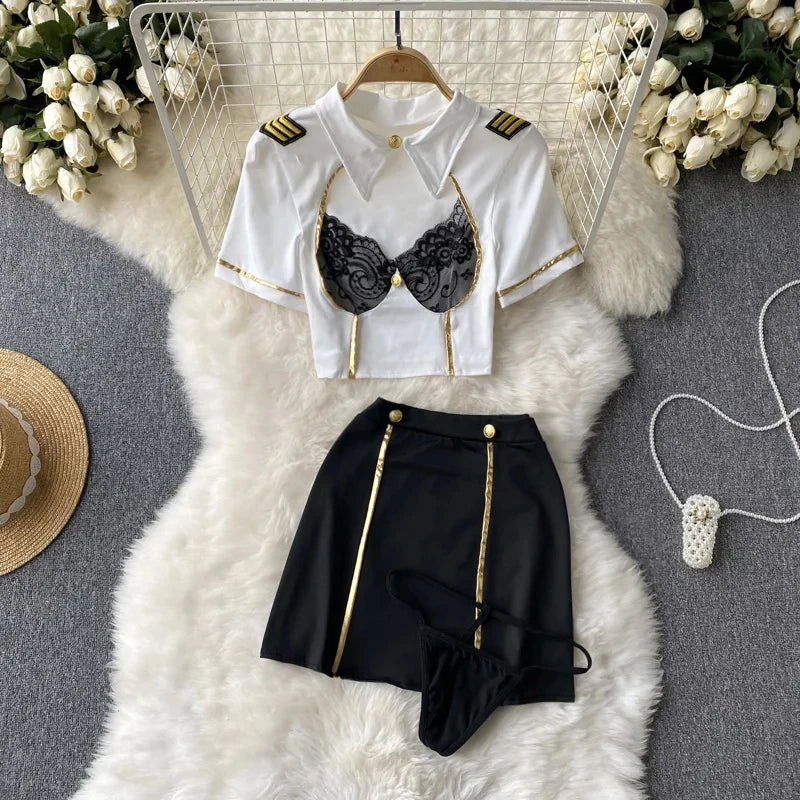 White shirt with gold accents and black lace bralette on a white fur rug.