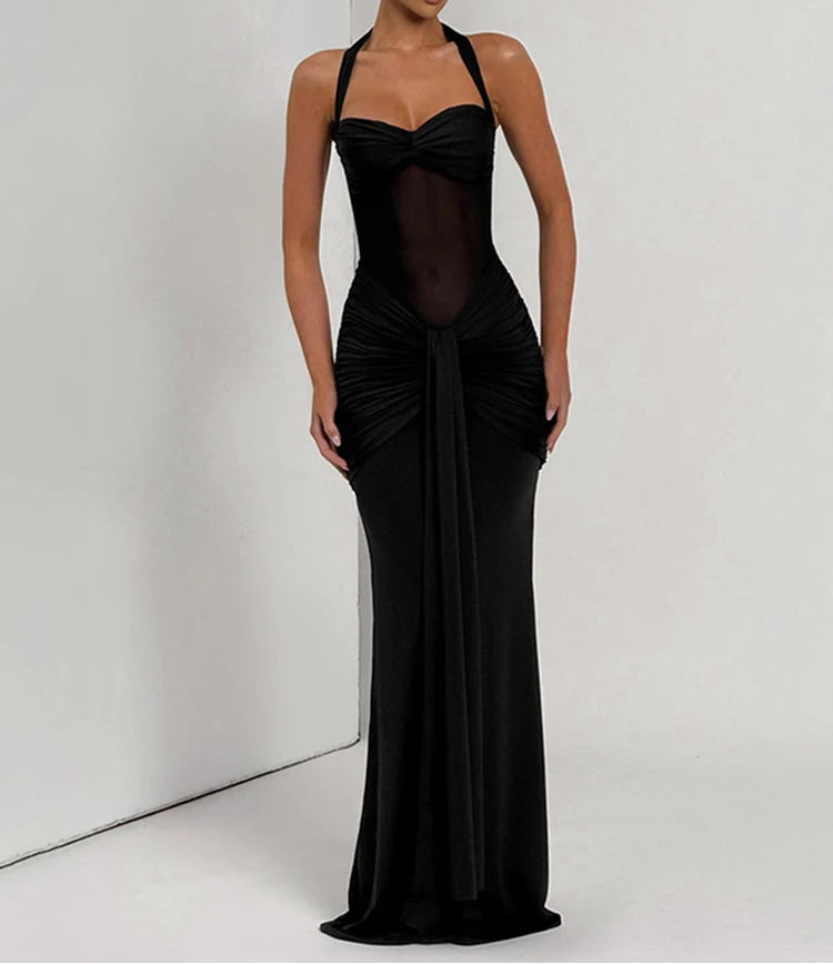 Woman wearing a black evening gown against a white background